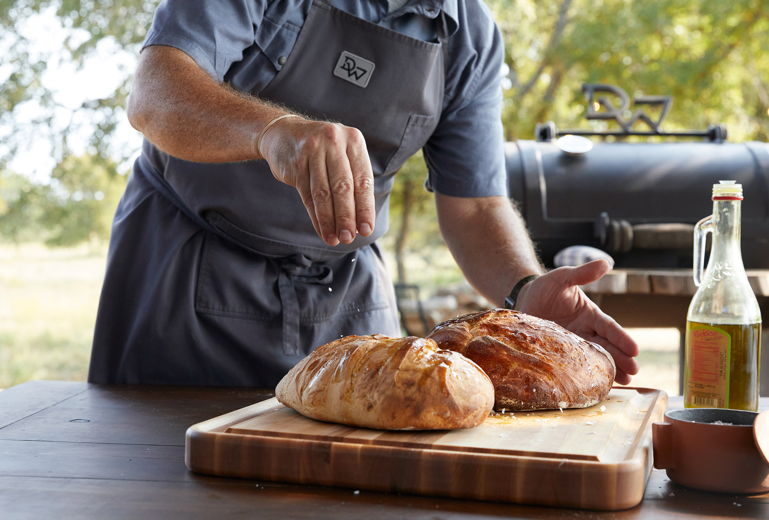 Chef making bread at outdoor oven in Texas by lifestyle photographer Buff Strickland