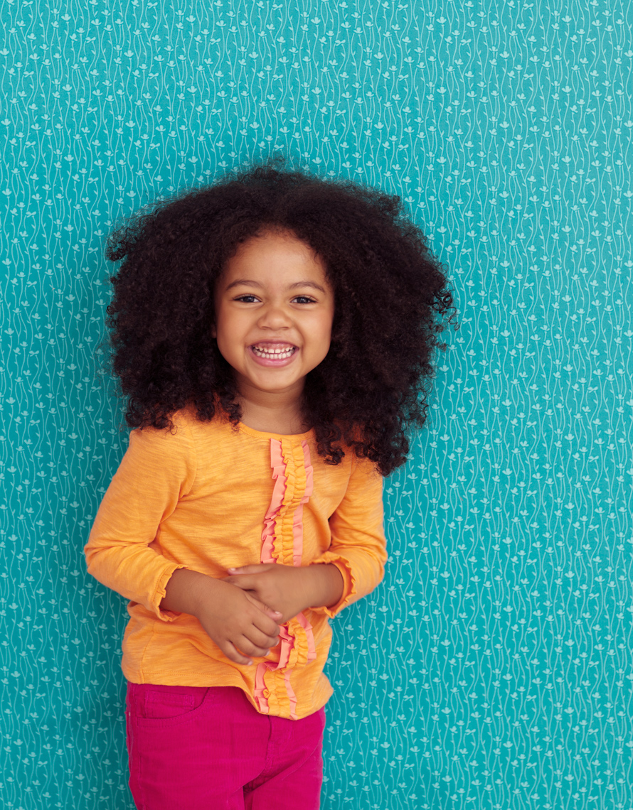 Black girl laughing by lifestyle photographer Buff Strickland