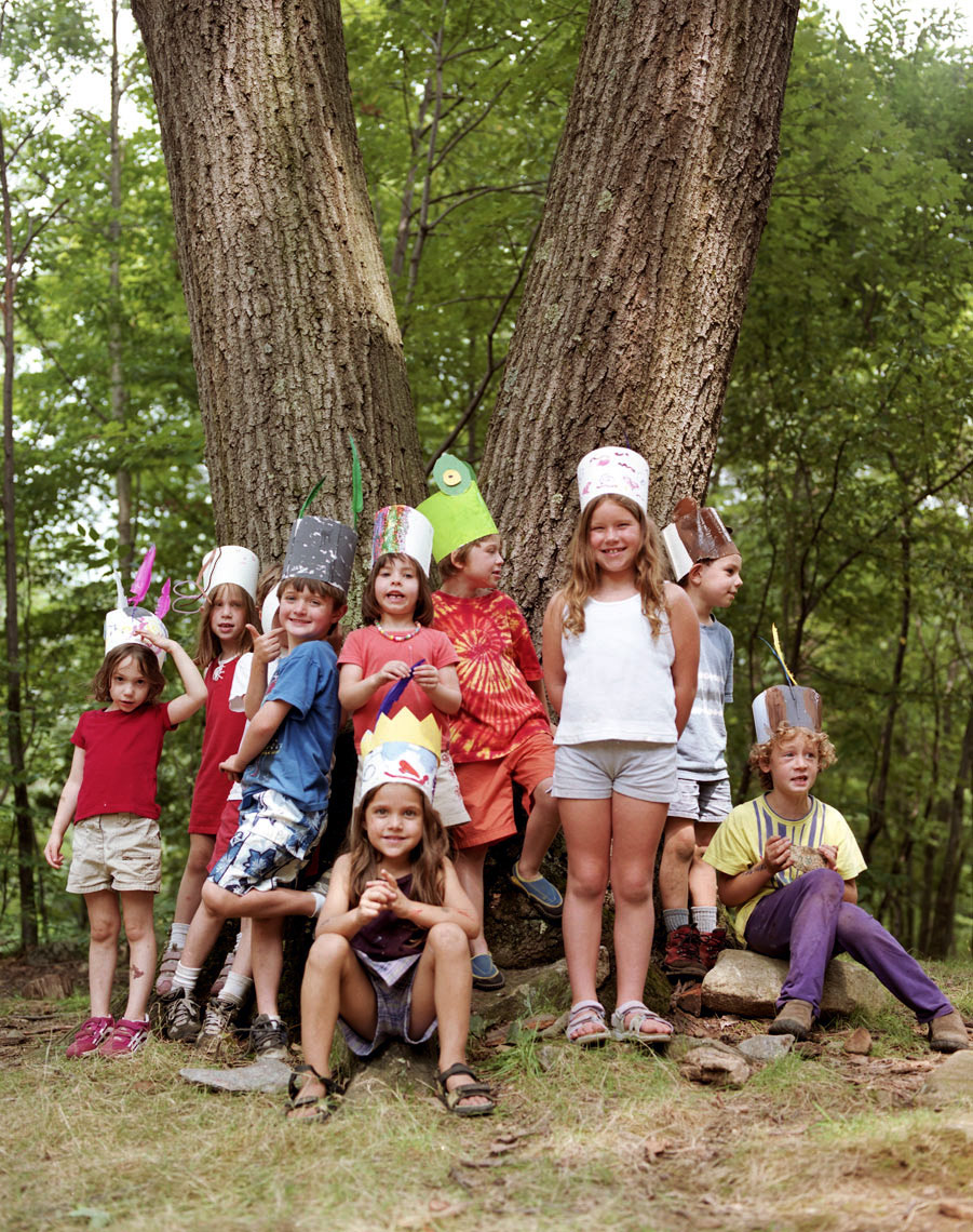 kids at summer camp family travel beneath a tree