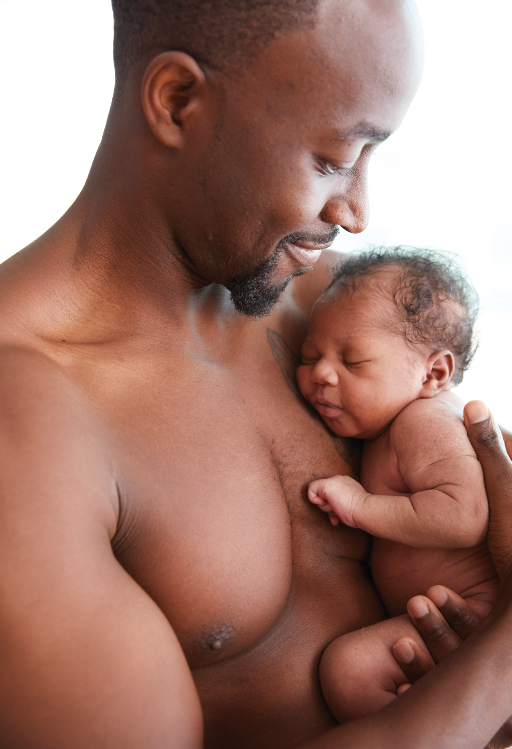 Texas health black man bonding with newborn by Buff Strickland photography