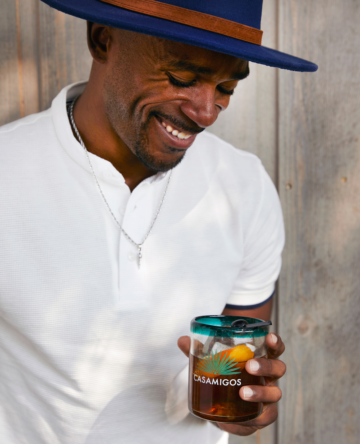Young black man in hat drinks Casamigos tequila drink Austin, Texas