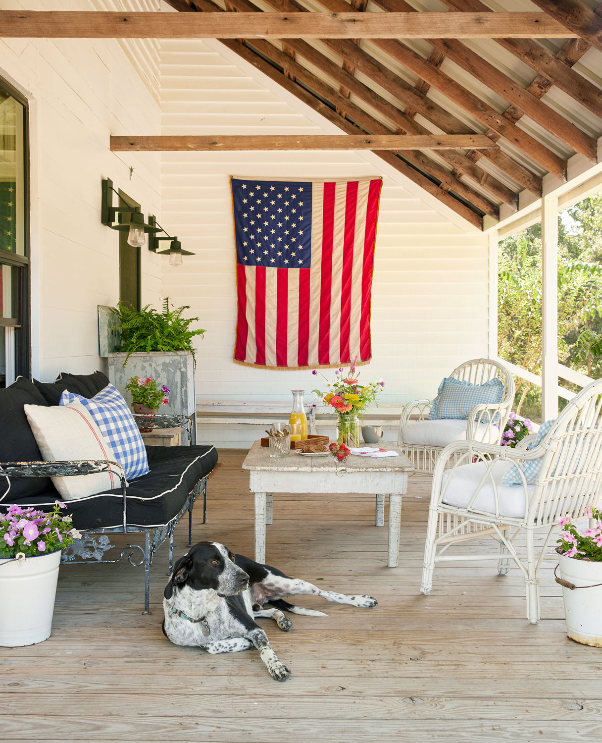 Front porch in Round Top with dog and American flag shot for Country Living magazine by Buff Strickland