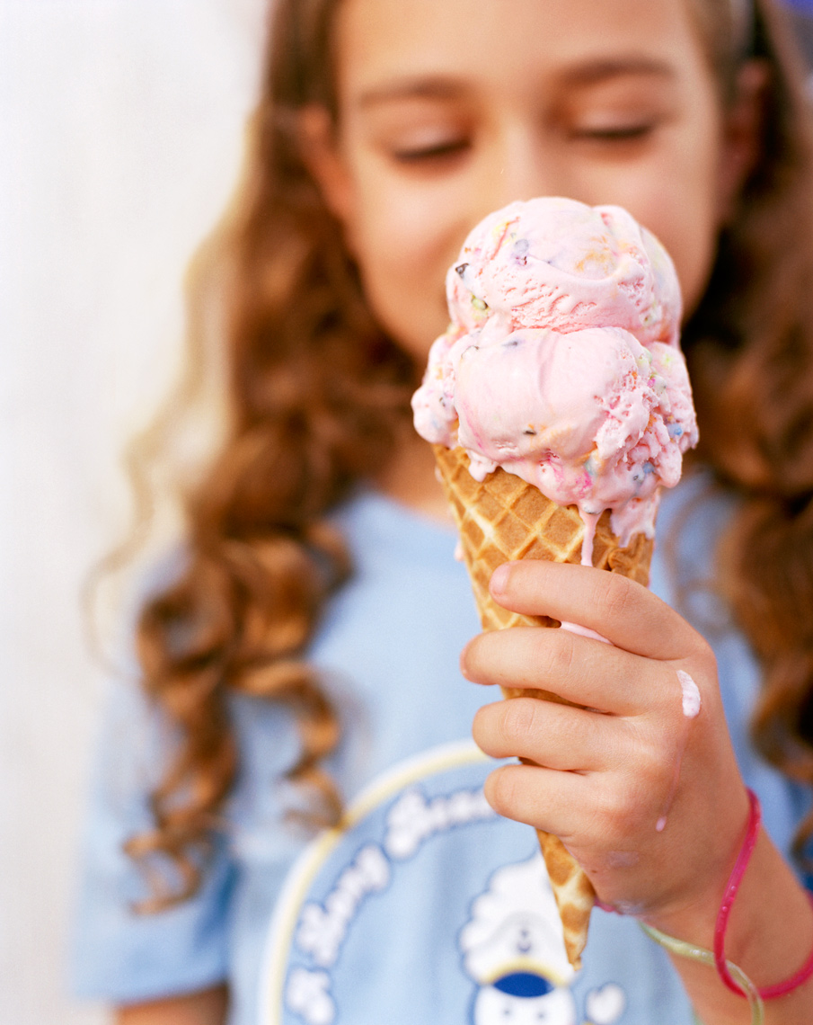 girl eating pink ice cream dripping down 