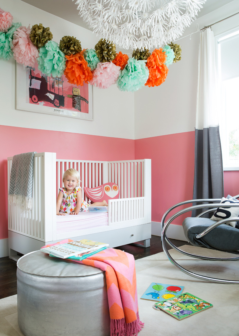 Stylish crib in babies room with lots of pink by lifestyle photographer Buff Strickland