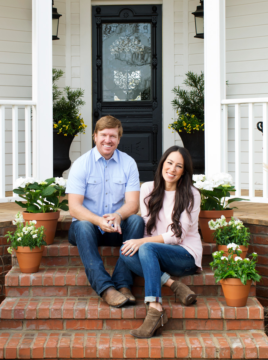 Chip and Joanna Gaines in front of Magnolia House by Austin based photographer Buff Strickland