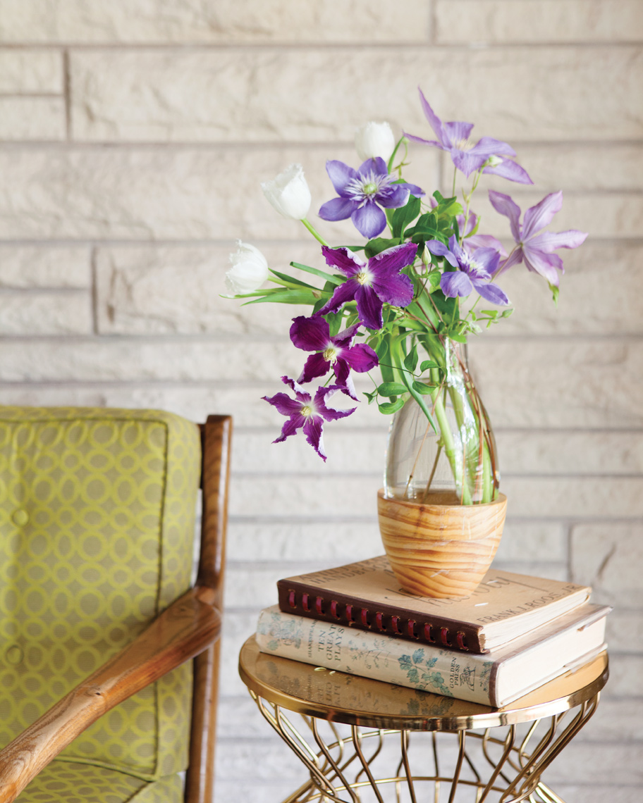 Camille Styles Entertaining living with spring flowers by modern chair