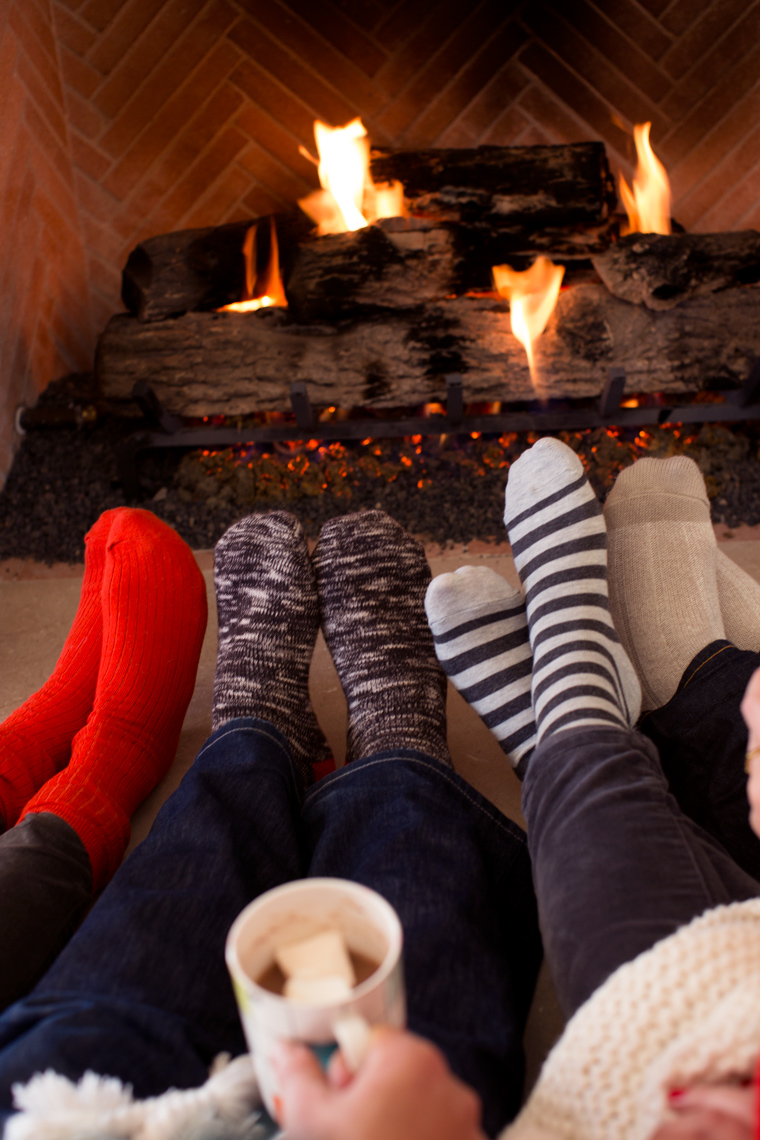 Camille Styles wool socks by the fire with Kate Spade mugs of hot chocolate