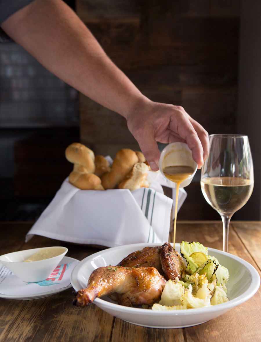houston restaurant of roasted chicken with gravy and rolls with wine