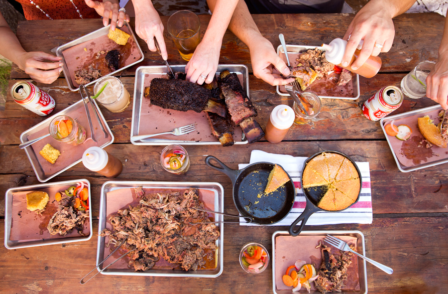 Texas Tailgate BBQ overhead on wooden table with beer and cornbread