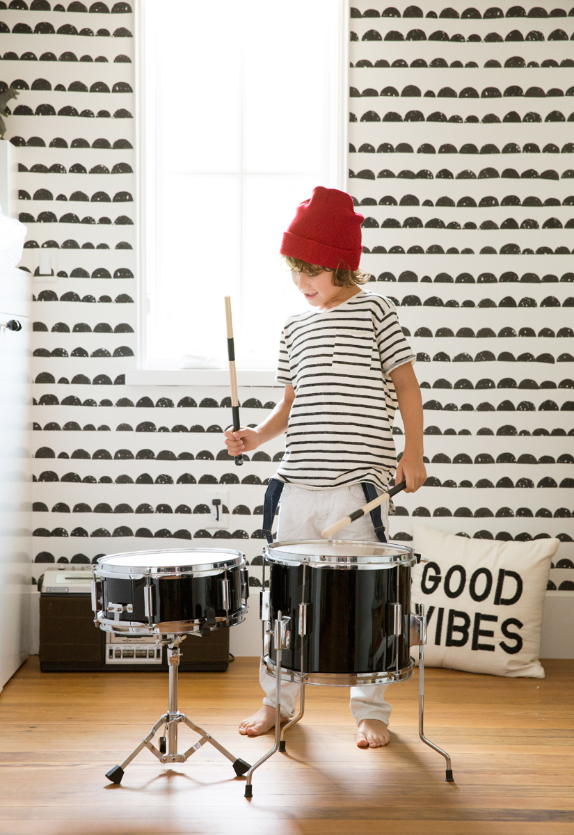 stylish kid playing drums Target pillow and red hat