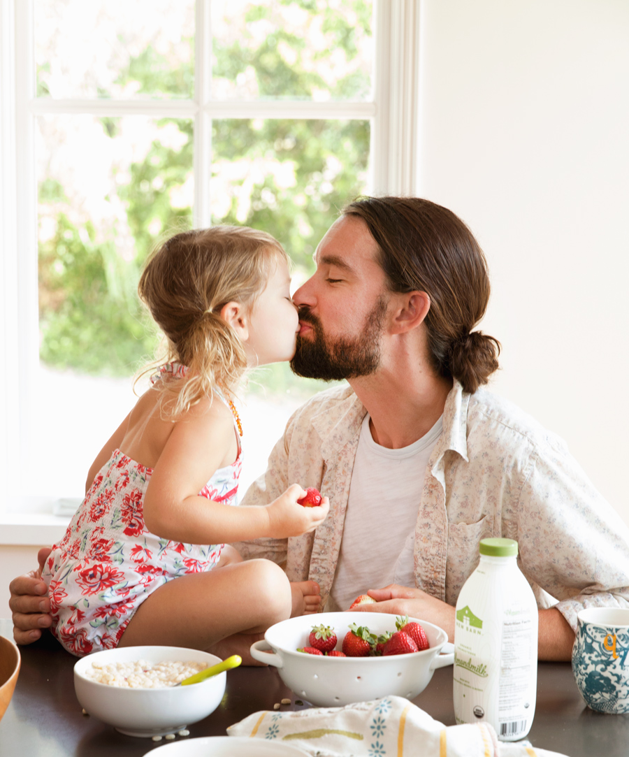 Dad eating breakfast of strawberries and cereal by Buff Strickland photography
