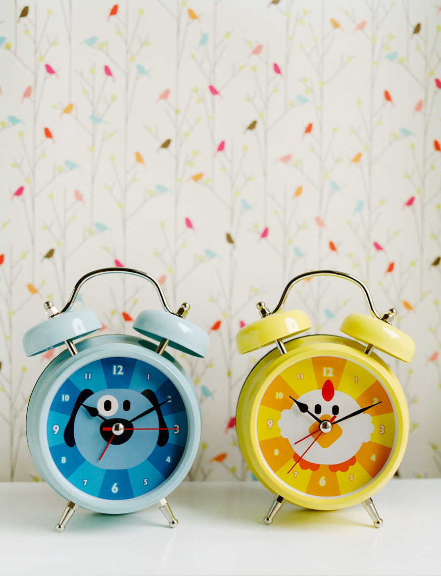 clocks on dresser with cute wallpaper