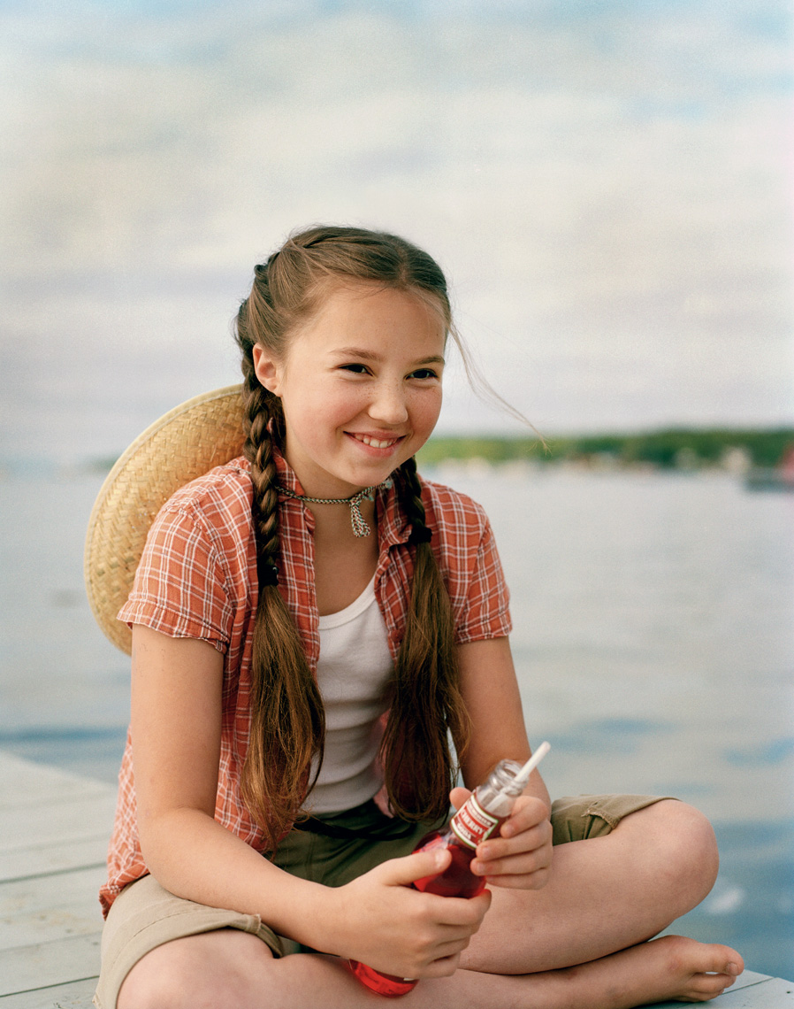 Door County girl on dock with soda for family travel magazine