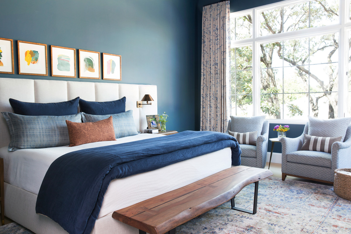 Elegant blue bedroom with large window by interior photographer Buff Strickland