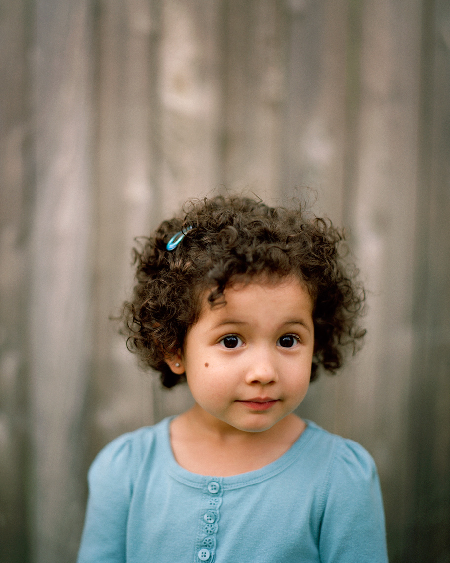 Small hispanic girl with smile in blue shirt