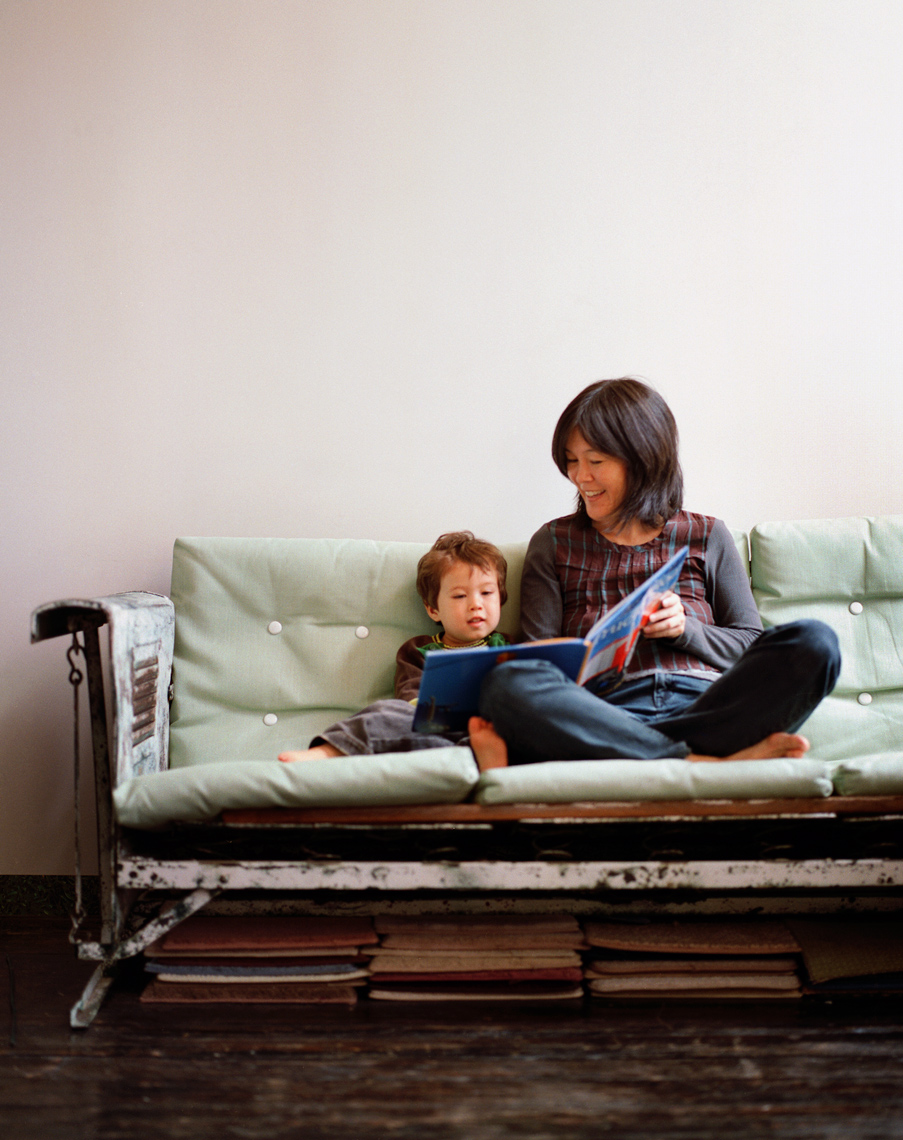 young boy and mom on couch reading a book